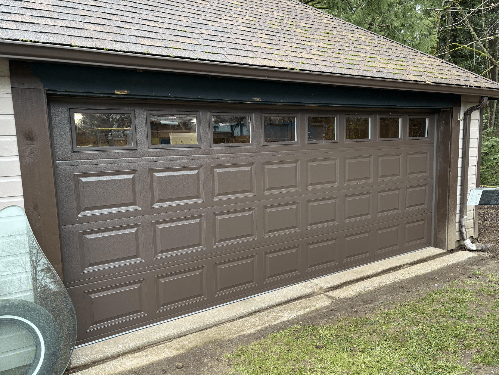 Brown garage door. This is a repair of a garage door.