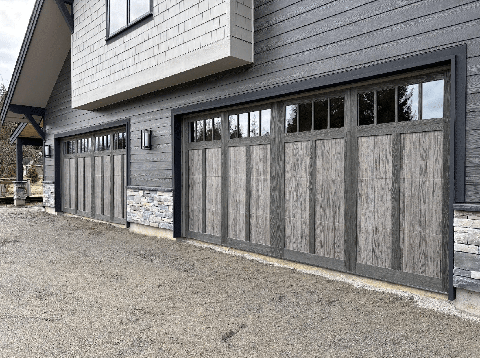 Garage doors installed with openers and glass on top.